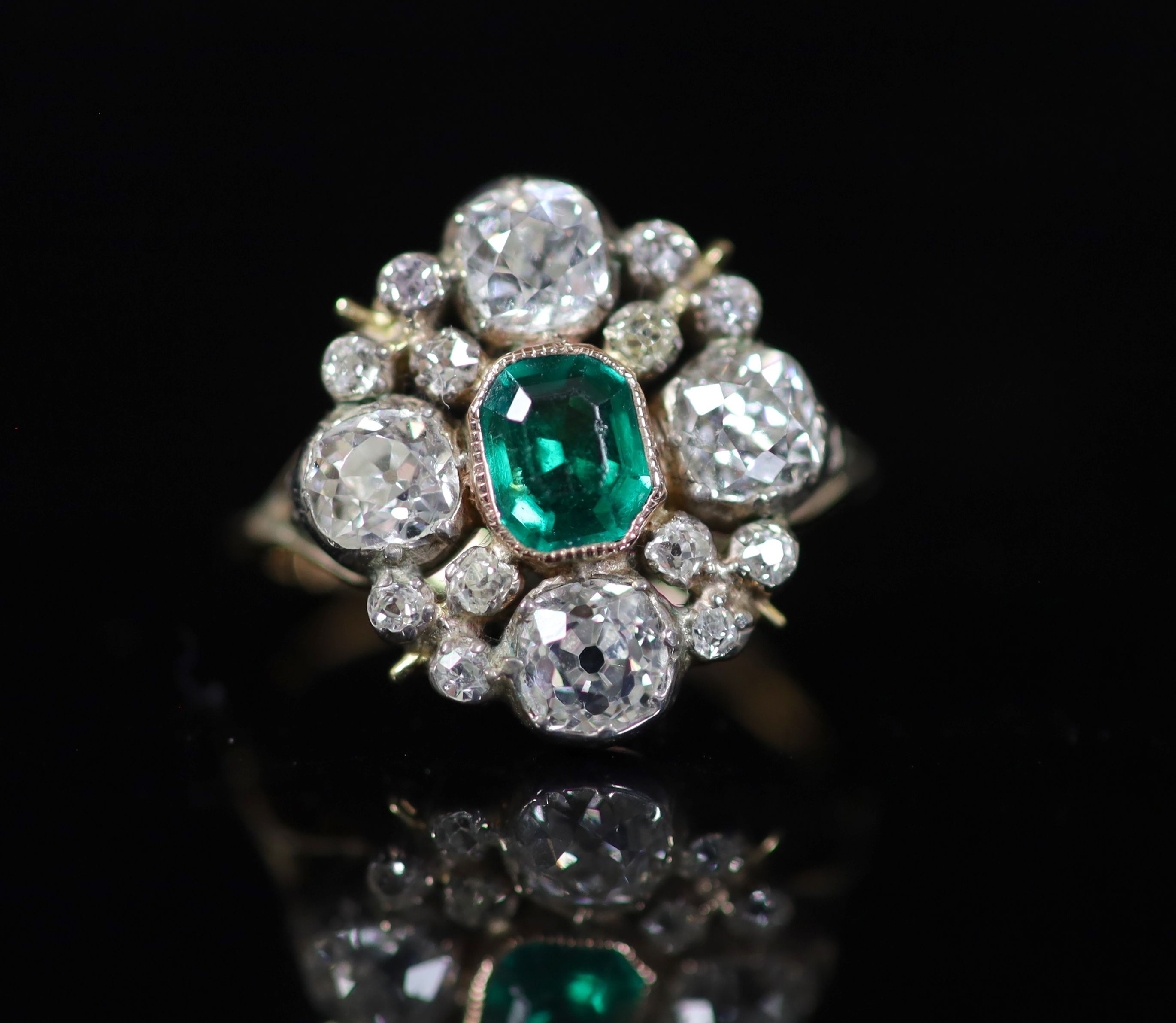 A 19th century gold and silver, emerald and diamond cluster dress ring